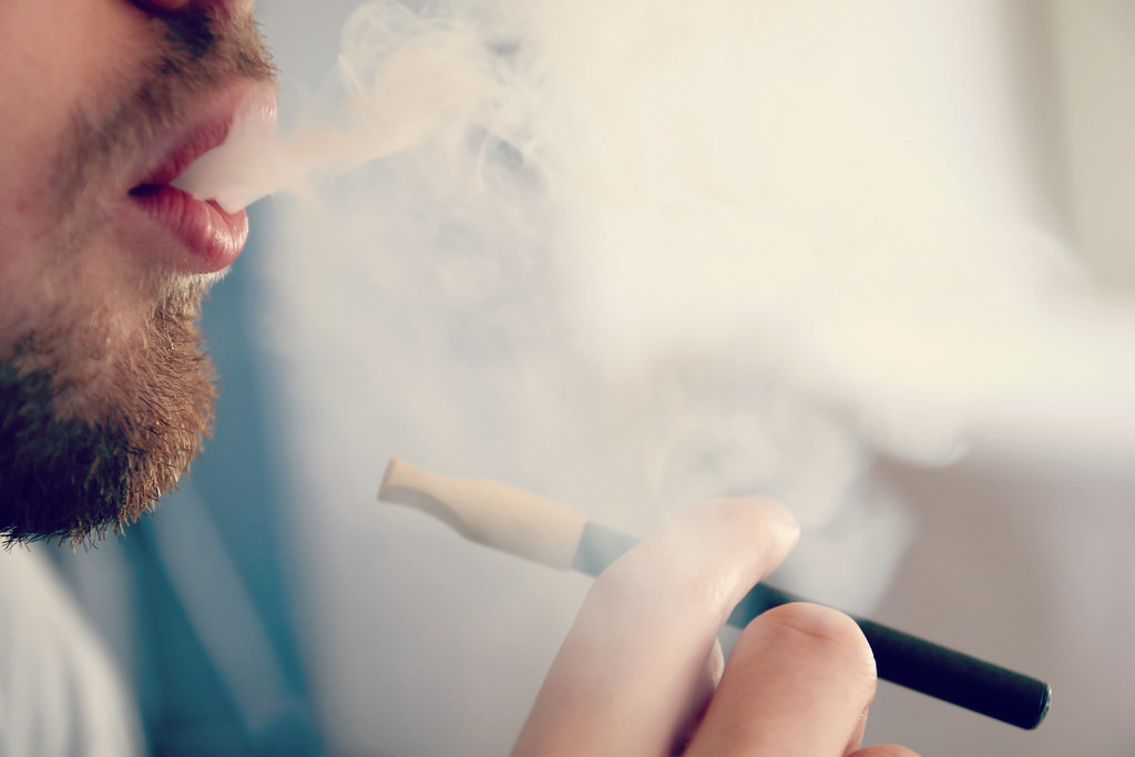 Man exhaling vapor from an e-cigarette
